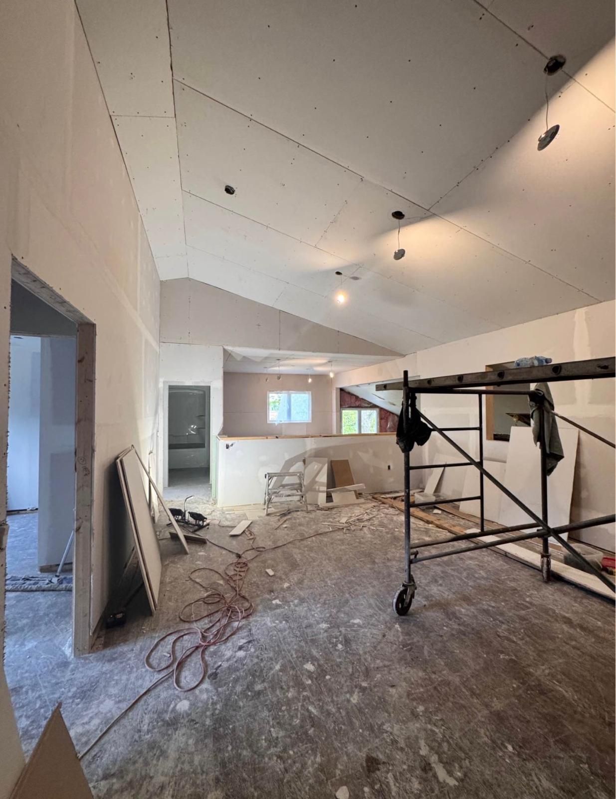 Vaulted ceiling room boarded with drywall mid renovation