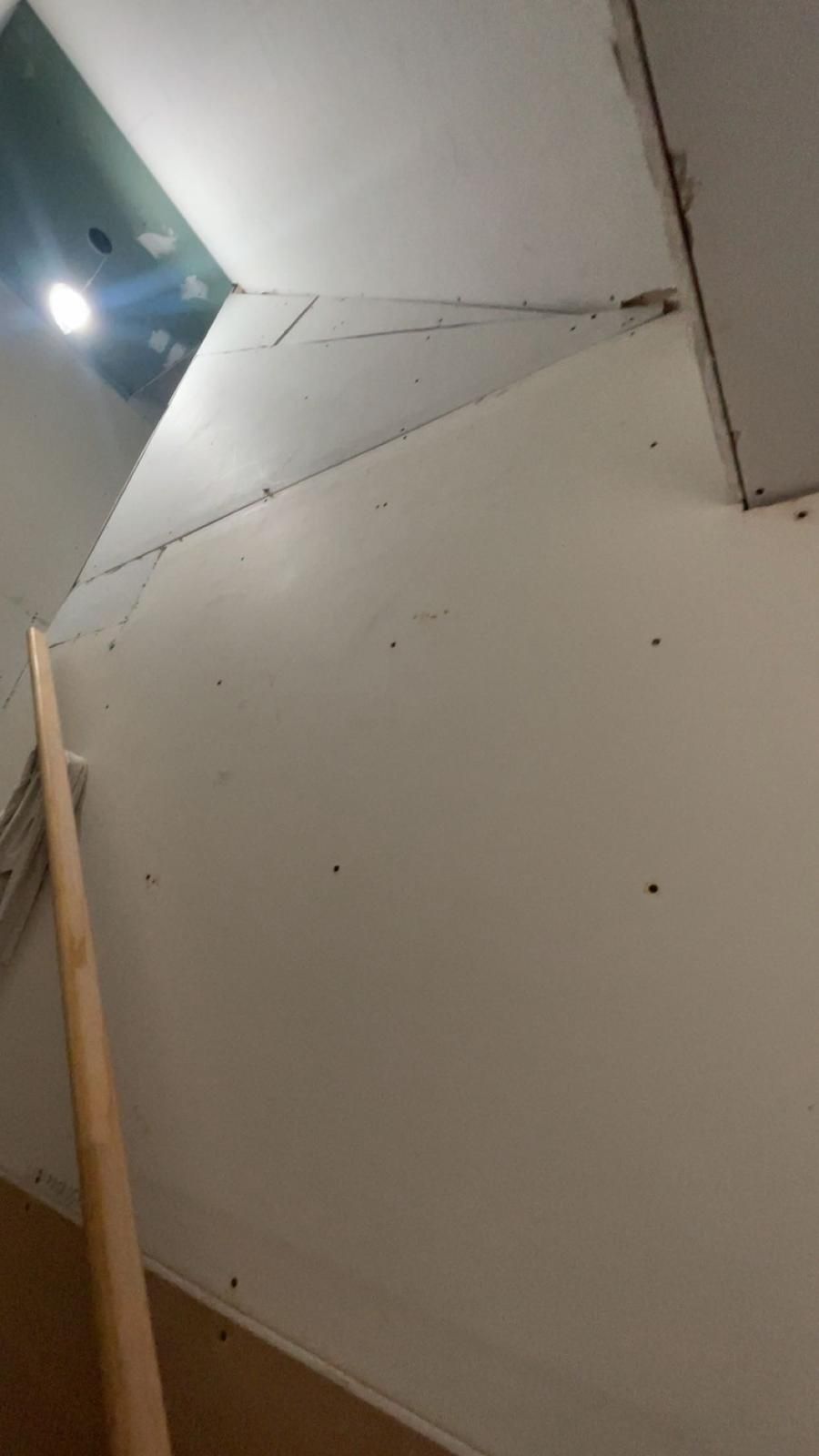 Taped drywall on the angled staircase wall