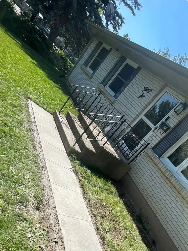 New concrete walkway and steps beside a house