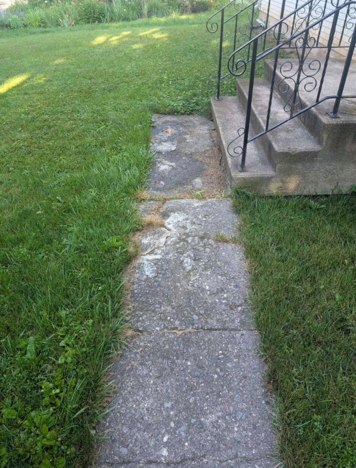 Old cracked walkway before replacement