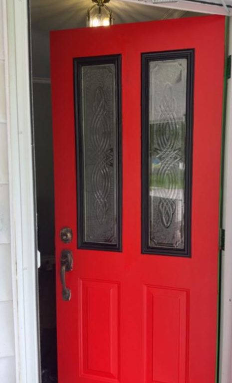 Front door after refinishing in deep red